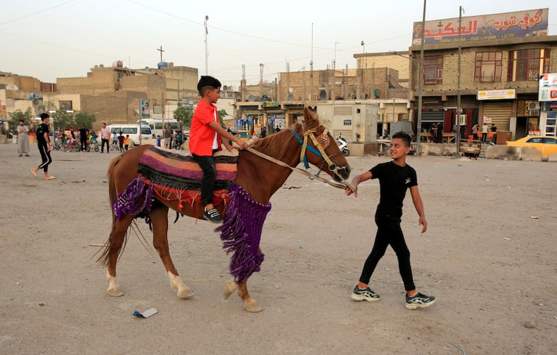 An Iraqi boy rides a horse during Eid Al Fitr celebrations at an amusement park in Sadr city, Baghdad, Iraq. EPA