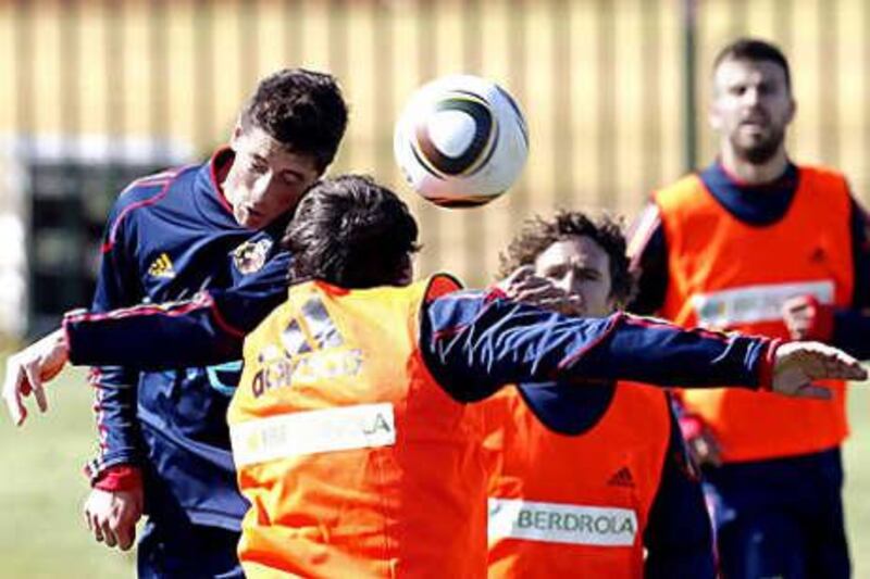 Fernando Torres wins an aerial challenge during a Spanish training session as the team prepare for their opening game of the World Cup against Switzerland today.