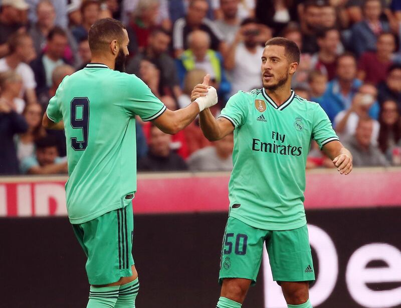 Hazard is congratulated by Karim Benzema on his goal. AFP