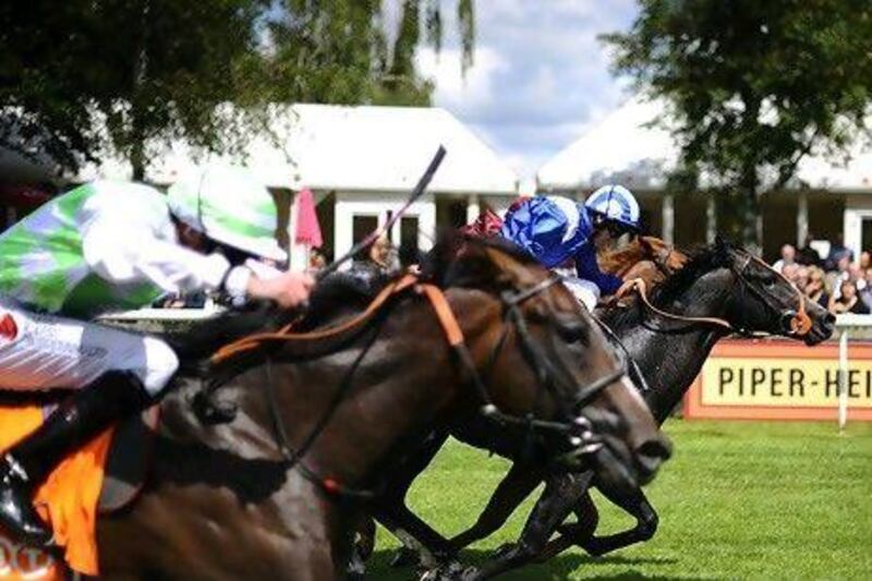 Paul Hanagan, in blue, rides Alhebayeb to victory.