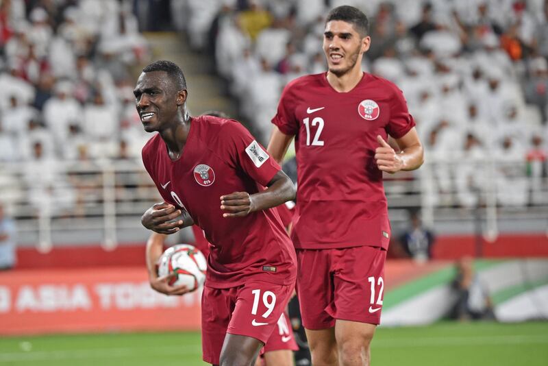 Qatar's forward Almoez Ali (L) celebrates his goal during the 2019 AFC Asian Cup semi-final football match between Qatar and UAE at the Mohammed Bin Zayed Stadium in Abu Dhabi on January 29, 2019.  / AFP / Roslan RAHMAN
