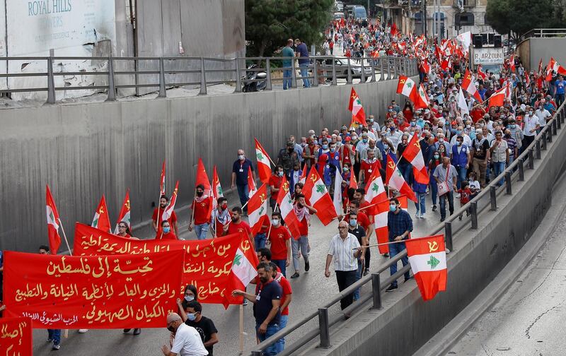 Supporters of the Lebanese Communist Party wave their party's flags as they march during a political festival to mark the 96th anniversary of the founding of the party, in central Beirut, Lebanon.  EPA