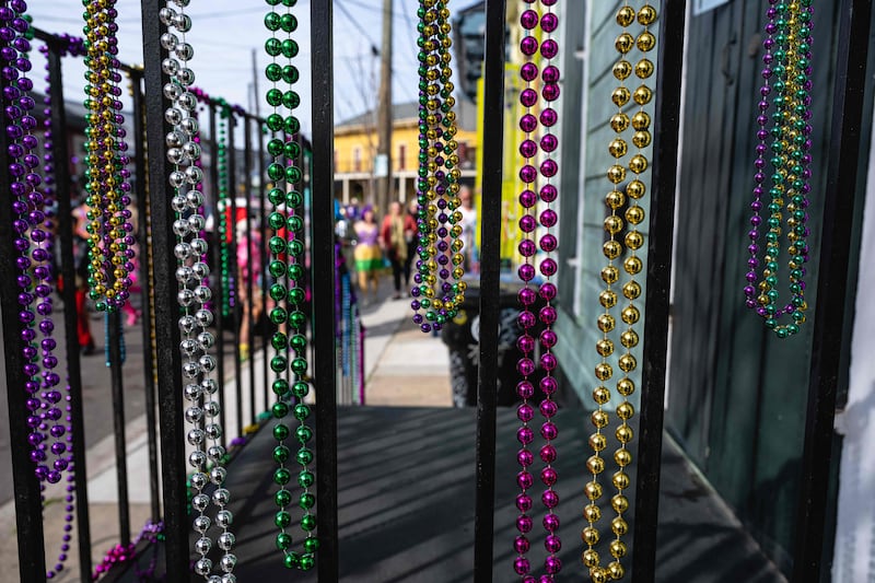 Mardi Gras beads, a well-known party item, hang from the banister of a front porch in New Orleans. AFP