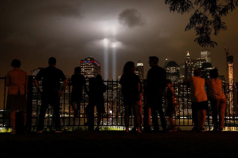 People look at the Tribute in Light installation in lower Manhattan as seen from the borough of Brooklyn. Reuters