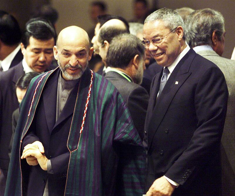 Afghan interim leader Hamid Karzai speaks to Powell at the International Conference on Reconstruction Assistance to Afghanistan in Tokyo, in January 2002. Reuters