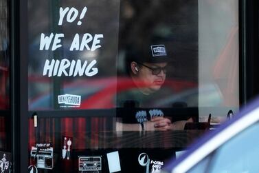 A hiring sign is displayed at a restaurant in Schaumburg, Ill. , Friday, April 1, 2022.  Despite the inflation surge, persistent supply bottlenecks, damage from COVID-19 and now a war in Europe, employers have added at least 400,000 jobs for 11 straight months.  (AP Photo/Nam Y.  Huh)
