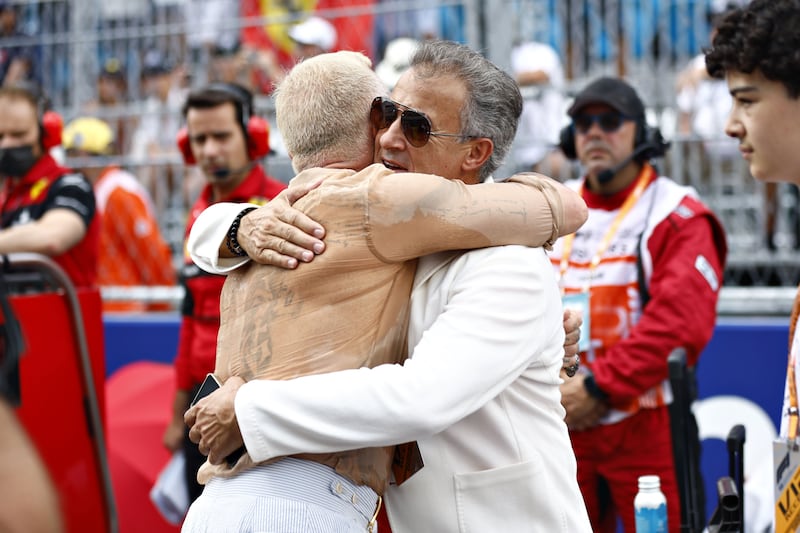 YouTube personality Gianluca Vacchi hugs former F1 driver Jean Alesi on the grid at the F1 Grand Prix of Miami. Getty

