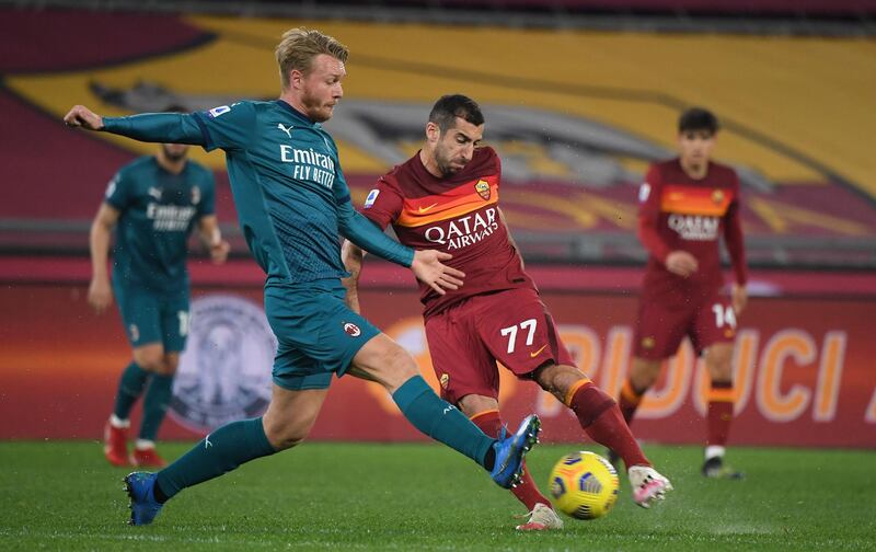 Roma's Henrikh Mkhitaryan in action with AC Milan's Simon Kjaer. Reuters