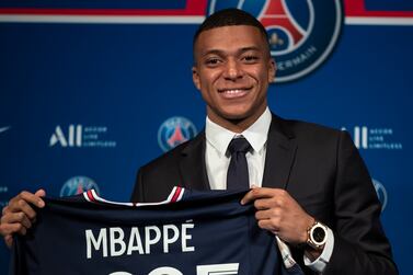 Paris Saint Germain's Kylian Mbappe poses with a PSG jersey after his press conference at the Parc des Princes stadium in Paris, France, 23 May 2022.  Kylian Mbappe renewed his contract with French Ligue 1 soccer club Paris Saint-Germain until 2025.   EPA / Christophe Petit Tesson