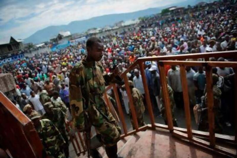 An M23 rebel soldier climbs the Volcanoes Stadium in Goma, where the rebel group’s spokesman, Vianney Kazarama, addressed the population in an attempt to calm and reassure civilians.