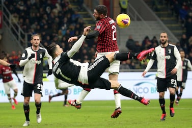 epa08216159 Juventus' Cristiano Ronaldo (L) challenges for the ball AC Milan's Davide Calabria during the first leg of the Coppa Italia semi final soccer match between AC Milan and Juventus at Giuseppe Meazza stadium in Milan, Italy, 13 February 2020. EPA/MATTEO BAZZI