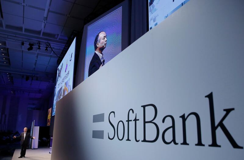 FILE - In this July 20, 2017, file photo, SoftBank Group Corp. Chief Executive Officer Masayoshi Son, left, speaks during a SoftBank World presentation at a hotel in Tokyo.  SoftBank will spend $2.25 billion for a nearly a 20 percent stake in General Motorsâ€™ autonomous vehicle unit. GM said Thursday, May 31, 2018, that it will also sink another $1.1 billion into Cruise Automation. The capital infusion is designed to speed large-scale deployment of self-driving robotaxis next year. (AP Photo/Shizuo Kambayashi, File)