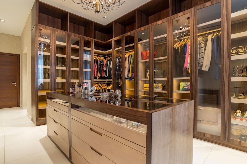 A walk-in closet can handle a brimming clothes collection. Courtesy LuxuryProperty.com