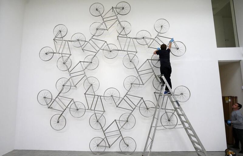 A gallery technician assembles a sculpture made from stainless steel bicycles entitled Forever by Ai Weiwei at the Lisson Gallery in London on May 22, 2014. Ai’s solo exhibition runs from May 23-July 19. Suzanne Plunkett / Reuters 