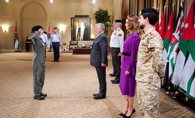 A handout picture released by the Jordanian Royal Palace on January 8, 2020 shows Jordanian King Abdullah II (C) welcoming his daughter Princess Salma bint Abdullah (L) for a ceremony to present her with her wings after completing her pilot training in the capital Amman.  - RESTRICTED TO EDITORIAL USE - MANDATORY CREDIT "AFP PHOTO / JORDANIAN ROYAL PALACE / YOUSEF ALLAN" - NO MARKETING NO ADVERTISING CAMPAIGNS - DISTRIBUTED AS A SERVICE TO CLIENTS
 / AFP / Jordanian Royal Palace / Yousef ALLAN / RESTRICTED TO EDITORIAL USE - MANDATORY CREDIT "AFP PHOTO / JORDANIAN ROYAL PALACE / YOUSEF ALLAN" - NO MARKETING NO ADVERTISING CAMPAIGNS - DISTRIBUTED AS A SERVICE TO CLIENTS
