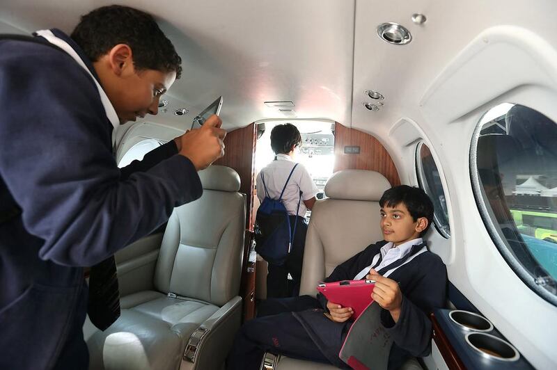 Grade 3 and grade 7 students from the Australian School of Abu Dhabi on board the Ministry of Presidential Affairs plane, which is on display at the Abu Dhabi Air Expo at Al Bateen Executive Airport. Delores Johnson / The National