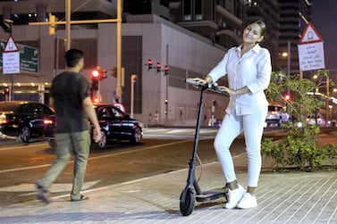Genesis Martinez rides an e-scooter from Dubai Marina to her workplace at Madinat Jumeirah. Victor Besa / The National