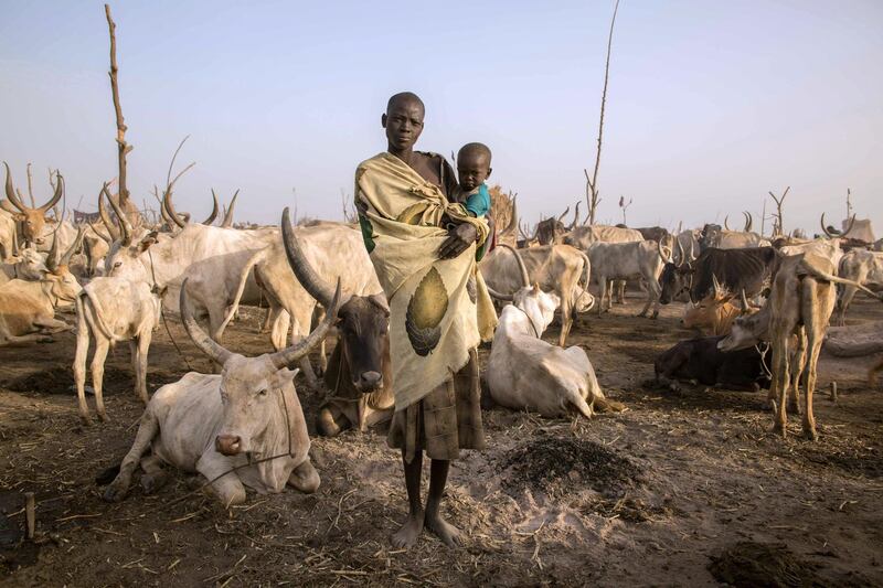 To mark the occasion of International Women's Day on March 8, 2018 AFP presents a series of 45 photos depicting women performing roles or working in professions more traditionally held by men.  More images can be found in www.afpforum.com  Search SLUG  "WOMEN-DAY -PACKAGE". 
South Sudanese cattle herder Mary Amer, 22, poses with her child in a camp in Mingkaman, South Sudan, on March 3, 2018.
In the ring, battling flames or lifting off into space, women have entered professions generally considered as men's jobs. For International Women's Day, AFP met with women breaking down the barriers of gender-bias in the work world. / AFP PHOTO / Stefanie GLINSKI