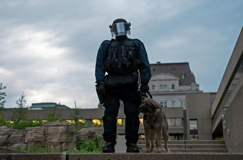 Riot police look on during the first anti G7 protest in Quebec City. Alice Chiche /  AFP