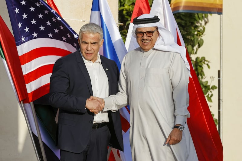 Mr Lapid, left, greets Bahraini Minister of Foreign Affairs Abdullatif Al Zayani on his arrival. AFP