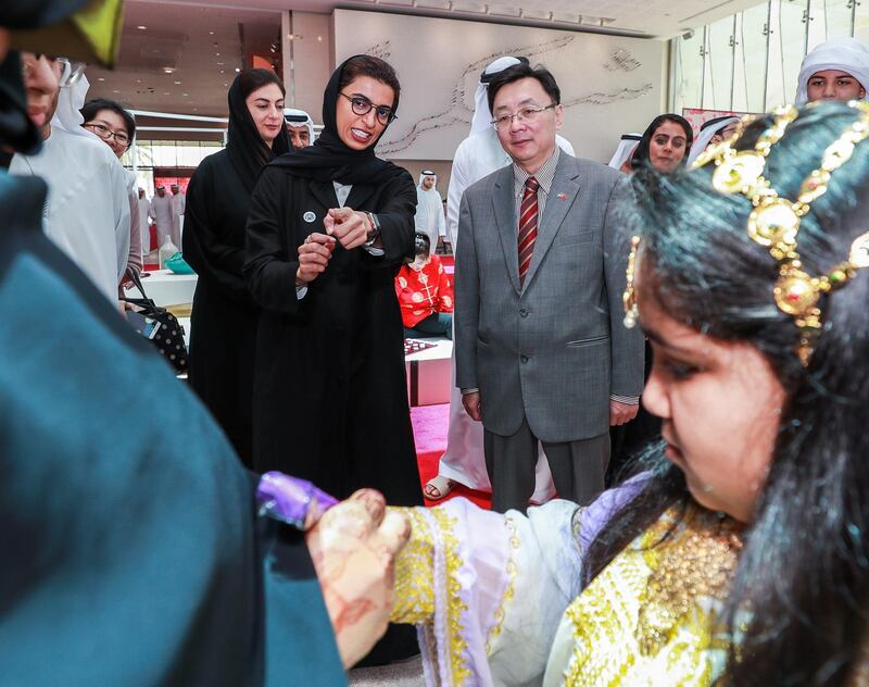 Abu Dhabi, U.A.E., July 17, 2018.   The Launch of China Week at Manarat Al Saadiyat with guests of honor, Noura Al Kaabi, Minister of Culture and Knowledge Development and Ni Jian, Ambassador of China (R) observe a henna arts activity.
 Victor Besa / The National
Section:  NA
Reporter:  John Dennehy