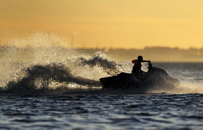 LEE-ON-THE-SOLENT, GOSPORT - MAY 20: Members of the public enjoy the sunny weather and relaxed government restrictions as they Jet Ski as the sun sets on May 20, 2020 in Lee-On-The-Solent, England . The British government has started easing the lockdown it imposed two months ago to curb the spread of Covid-19, abandoning its 'stay at home' slogan in favour of a message to 'be alert', but UK countries have varied in their approaches to relaxing quarantine measures. (Photo by Naomi Baker/Getty Images)