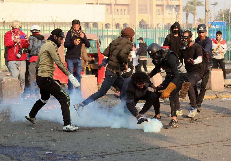 Riot police fire tear gas to disperse anti-government protesters during clashes with anti-government protesters in Baghdad. AP Photo