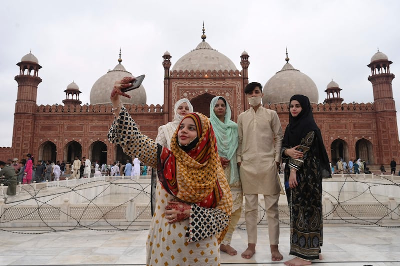 A woman takes a selfie with her friends after prayers at the historical Badshahi Mosque during Eid Al Adha in Lahore, Pakistan.