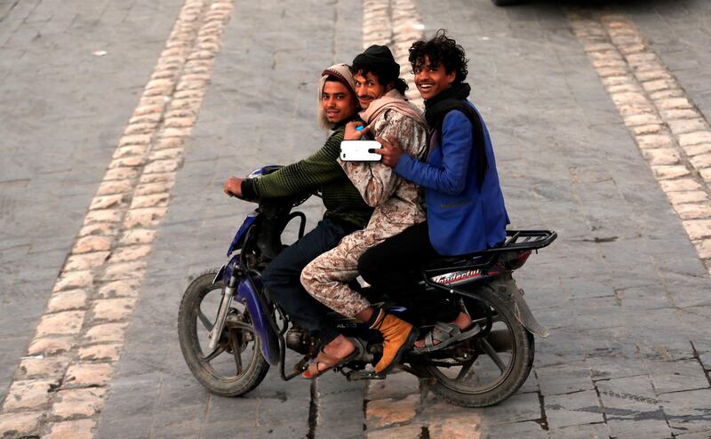 Yemenis ride a motorcycle in the old quarter of Sanaa, Yemen.  EPA