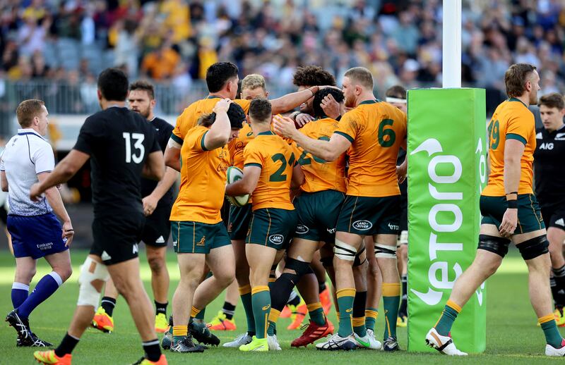 Australian players celebrate a try by Nic White during a rugby match against New Zealand in Perth.  AFP