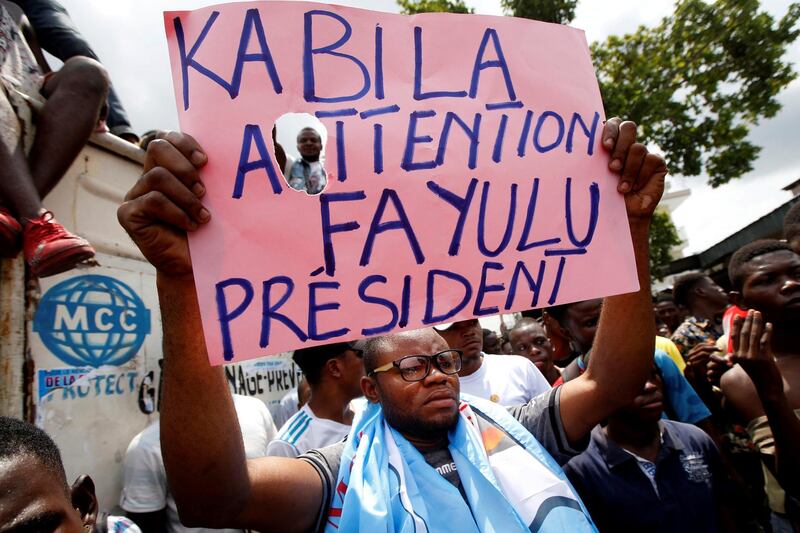 FILE PHOTO: Supporters of the runner-up in Democratic Republic of Congo's presidential election, Martin Fayulu hold a sign before a political rally in Kinshasa, Democratic Republic of Congo, January 11, 2019. REUTERS//File Photo