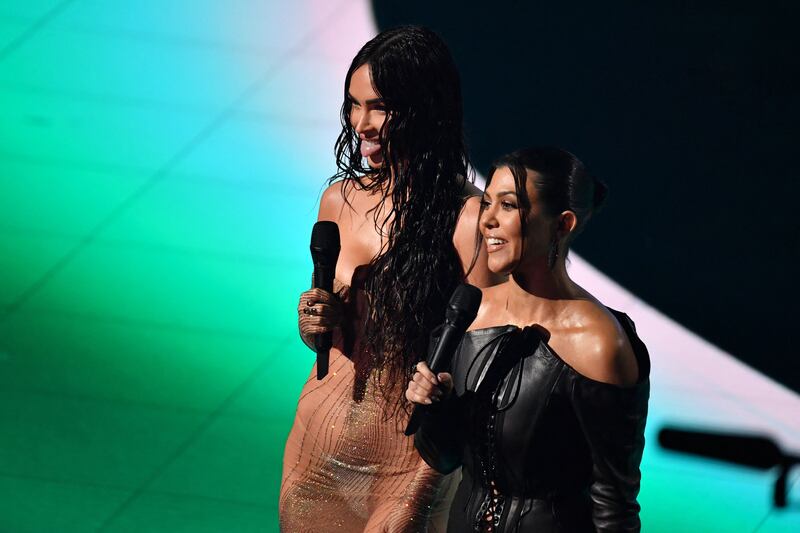 Actress Megan Fox, left, and Kourtney Kardashian speak on stage. AFP