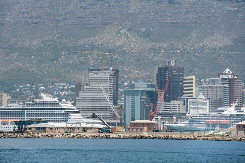 A view of cruise ships docked in the Cape Town Harbour, with the city and Table Mountain in the background on January 16, 2020, in Cape Town. (Photo by RODGER BOSCH / AFP)