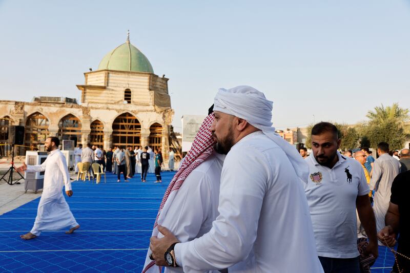 Worshippers share greetings after Eid Al Adha prayers at Al Nouri Mosque in Mosul, northern Iraq. Reuters 