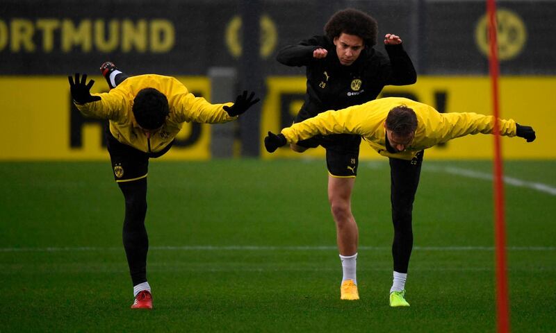 Dortmund's Mats Hummels and Axel Witsel do stretching exercises. AFP