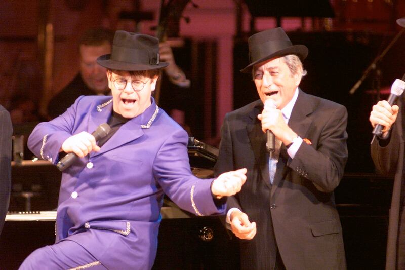 Elton John, in a lilac suit, with Tony Bennett on stage at the Rainforest Foundation Benefit at Carnegie Hall in New York City on April 17, 1999. ImageDirect