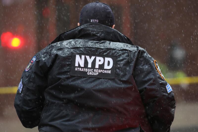 New York City Police Department (NYPD) officer arrives at 787 7th Avenue. Reuters