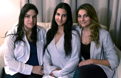 Amer Fakhoury's daughters, Guila, Macy, and Zoya Fakhoury, gather in Salem, New Hampshire. He was accused of torturing and killing inmates at a former prison where his family says he had worked as a clerk. AP