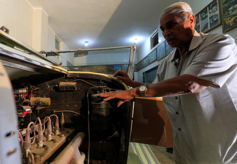 Sayed Sima checks a 120-year-old American 1900 Auburn automobile in his store. Reuters