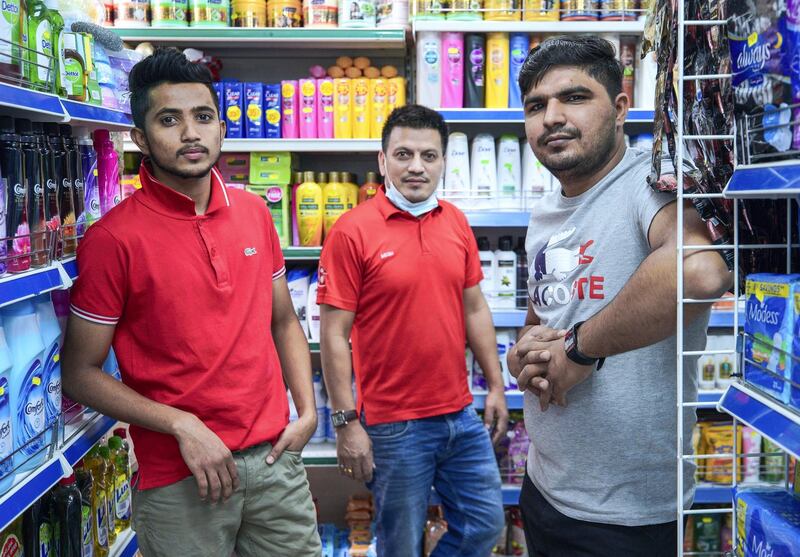Abu Dhabi, United Arab Emirates, October  22, 2020.  Haneen Dajani does follow up interviews of local residents and workers at the KFC explosion neighborhood on Airport Road.
Workers of Green House Baqala, left, Jehan Ameen, Megh Thapa and Mohammad Bilal who were on duty during the explosion.
Victor Besa/The National.
Section:  NA
Reporter:  Haneen Dajani