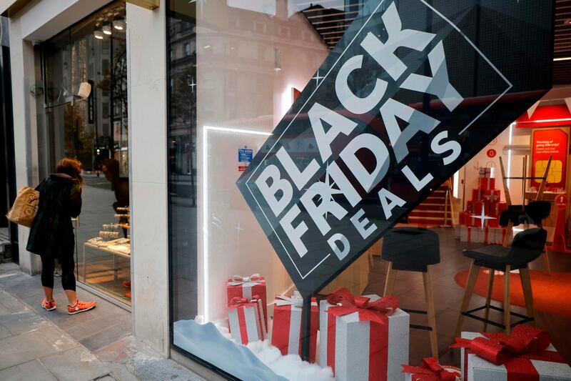 A sign for "Black Friday Deals" is seen in the window of a shop in central London. AFP