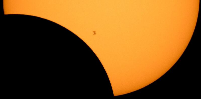 The International Space Station is silhouetted against the sun during a partial solar eclipse as seen from Ross Lake, Northern Cascades National Park, in Washington. Bill Ingalls / NASA via AP