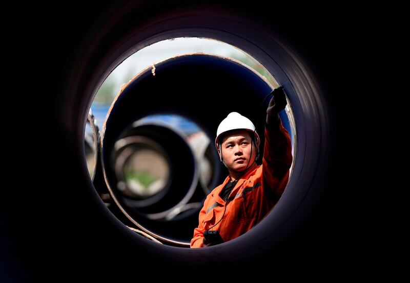 A worker measures a steel pipe at a factory in Zouping in China's eastern Shandong province. AFP Photo
