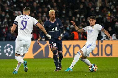 Real Madrid's Karim Benzema, left, watches Real Madrid's Jesus Vallejo controlling the ball while PSG's Neymar, center, looks on during the Champions League round of 16, first leg, soccer match Paris Saint-Germain against Real Madrid at the Parc des Princes stadium in Paris, Tuesday, Feb. 15, 2022.  (AP Photo / Michel Euler)