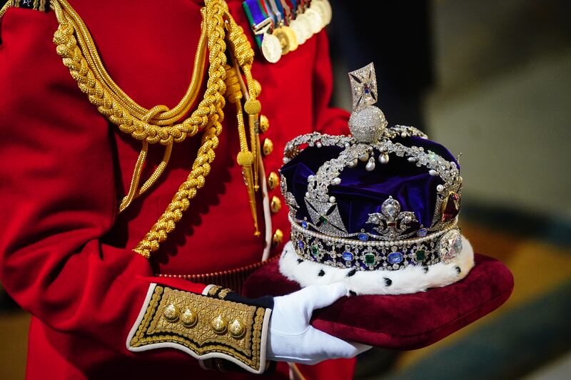 The Imperial State Crown arrives at the sovereign's entrance to the Palace of Westminster. PA