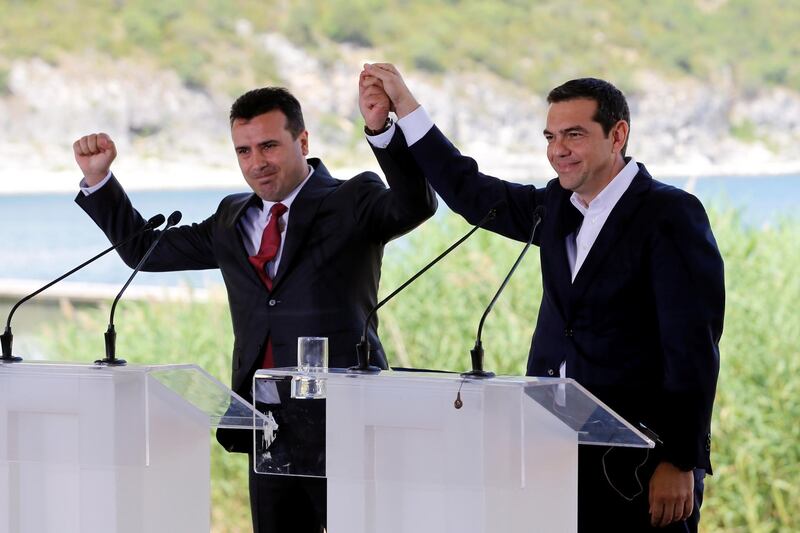Greek Prime Minister Alexis Tsipras and Macedonian Prime Minister Zoran Zaev gesture before the signing of an accord to settle a long dispute over the former Yugoslav republic's name in the village of Psarades, in Prespes, Greece, June 17, 2018. REUTERS/Alkis Konstantinidis