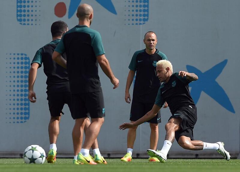 Neymar, right, and teammate Gerard Pique, second from right. Lluis Gene / AFP