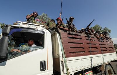 Members of Amhara region militias ride on their truck as they head to face the Tigray People's Liberation Front (TPLF), in Sanja, Amhara region near a border with Tigray, Ethiopia November 9, 2020. REUTERS/Tiksa Negeri
