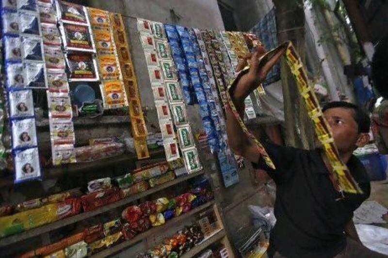 A vendor arranges sachets of gutka at his roadside stall in Kolkata. Ten Indian states have banned the popular chewing tobacco made of crushed betel nut, nicotine and laced with thousands of chemicals.