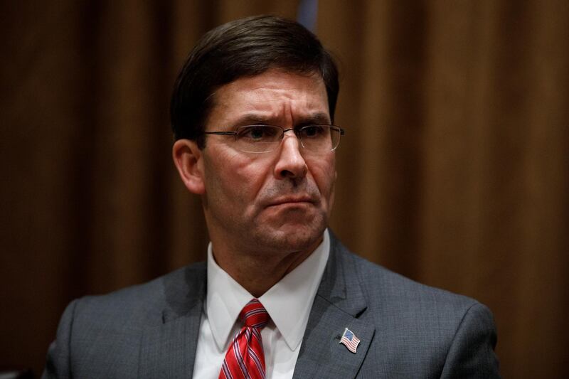 FILE - In this Oct. 7, 2019, file photo, Defense Secretary Mark Esper participates in a briefing with President Donald Trump and senior military leaders in the Cabinet Room at the White House in Washington. Esper declared on Monday, Nov. 25 that President Donald Trump ordered him to stop a disciplinary review of a Navy SEAL accused of battlefield misconduct, an intervention that raised questions about Americaâ€™s commitment to international standards for battlefield ethics. (AP Photo/Carolyn Kaster, File)